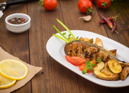 Deep Fried Dolly Fish Steak with French fries. Wooden background. Top view. Close-up