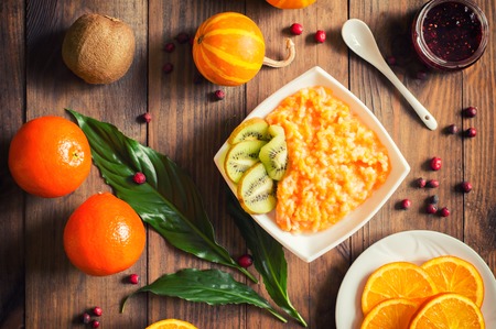 Pumpkin porridge with fruit. Autumn still-life. A rustic style. Wooden background. Top viewの写真素材