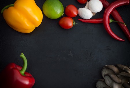 Different vegetables on a black stone background. Top viewの写真素材