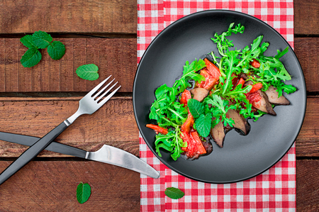 Warm salad, Duck with arugula, tasty, fashionable food, new dish serving. Wooden rustic background. Top view. Selective focusの写真素材