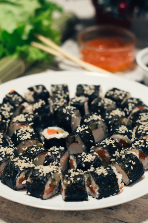 Sushi on the plate. Popular sushi japan food. Wooden rustic background. Top view.の写真素材