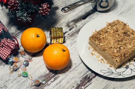 Slice of sweet classic layered cake Napoleon. Wooden rustic background. Top viewの写真素材