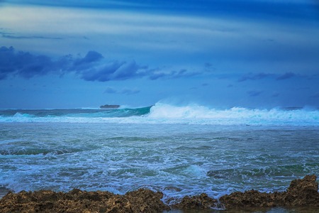 Beautiful sea landscape on the background of dramatic cloudy sky and corals. Siargao island, Philippines.の写真素材