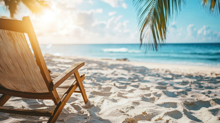 Wooden deck chair on the beach with palm tree and sea backgroundの素材