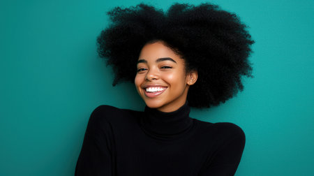 Young african american woman with afro hairstyle against green backgroundの素材