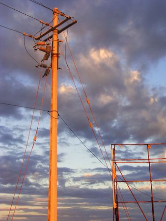 Electricity post, cables and metal structure with a purple cloudy afternoon skyの写真素材