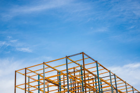 Minimal Construction building with a blue sky and white clouds background.