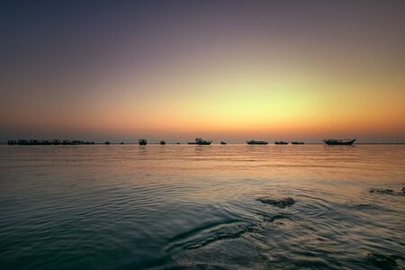 Beautiful Sunrise Boat in seaside with red and dark sky. Dammam -Saudi Arabiaの写真素材