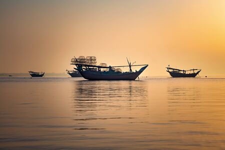 Beautiful Sunrise Boat in seaside with yellow sky. Dammam -Saudi Arabiaの写真素材
