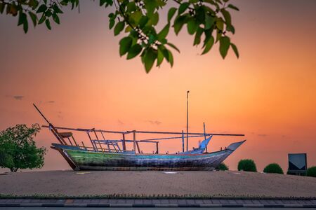 Beautiful Sunrise Boat in seaside with yellow sky background. Dammam -Saudi Arabiaの写真素材