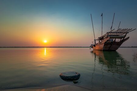 Beautiful Sunrise Boat in seaside with yellow and blue sky background. Dammam -Saudi Arabia