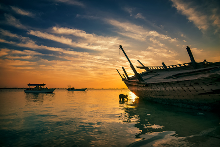 Beautiful Sunrise Boat in seaside with yellow and blue sky background. Dammam -Saudi Arabiaのeditorial素材