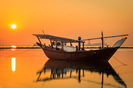 Beautiful Sunrise Boat in seaside with yellow sky background. Dammam -Saudi Arabiaのeditorial素材