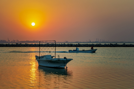 Beautiful Sunrise Boat in seaside with yellow sky. Dammam -Saudi Arabiaのeditorial素材