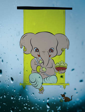 Illustration drawing of lord ganesha eating laddu with his favourite ratの写真素材
