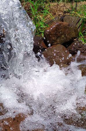 Beautiful Water splashing droplets falling in rocksの写真素材