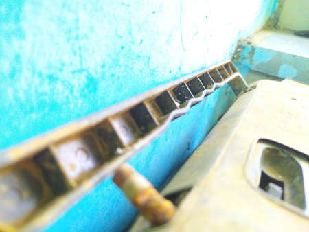 Vintage old radio FM instrument handle and broken antenna with turquoise blue backgroundの写真素材