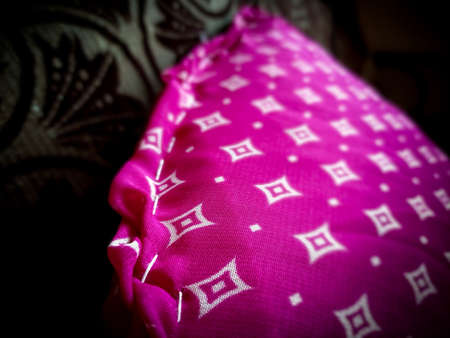 Lovely weave of red comfortable pillow in white diamond textures. Bright colours.の写真素材