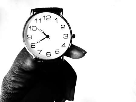 A wrist watch holding in hand by poor man. Black and white.の写真素材