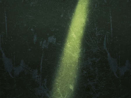 Light beam of torchfall down on green textured wall wall