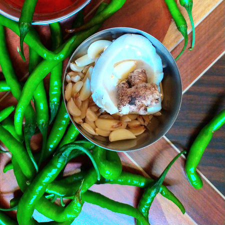 Thai food and green chillies on a wooden tableの写真素材
