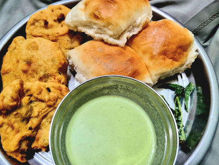 Delicious Vadapav and chutney breakfast meal on a plate, close-up and appetizing.の写真素材