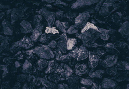 Three white chalk stones isolated industrial rustic charcoal carbon mining background in black and whiteの写真素材