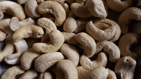 a close up shot of cashew nuts gathering its healthy foodの写真素材