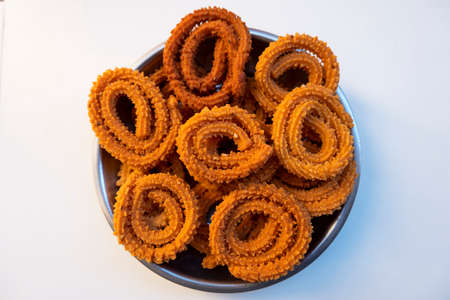a top shot of traditional chakali snacks isolated on white backgroundの写真素材