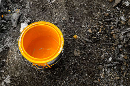 a close view of yellow color bucket on groundの写真素材