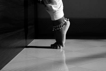 Indian girl child silver anklet isolated in bare feetの写真素材