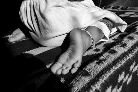 a close view of Indian girl child W sitting position in black & white photoの写真素材