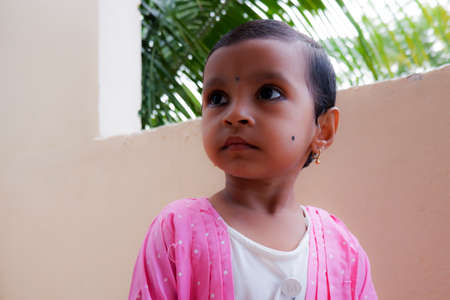 a closeup shot of Indian girl child in morning sunlight, Kalaburagi, Karnatka/India-September 24.2020のeditorial素材