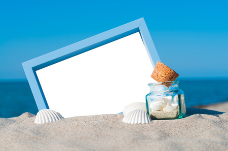 Blank picture frame in the sand with maritime decorationの写真素材