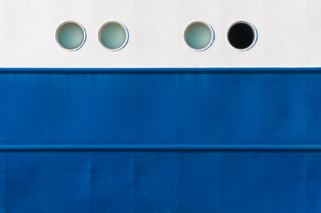 White and blue laquered side of a vessel with portholes; Varnished side of a ship for background; Seafaringの写真素材