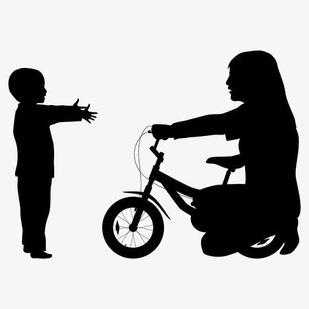 Mom giving son a bicycle silhouetteの写真素材