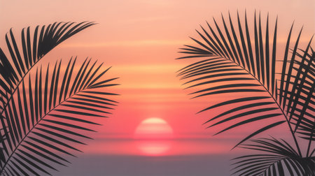 Silhouetted palm fronds frame a vibrant tropical sunset with hues of orange, pink, and red over a calm, reflective ocean.の素材
