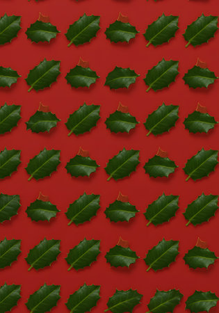 Seamless pattern of holly leaves on a red background.の素材