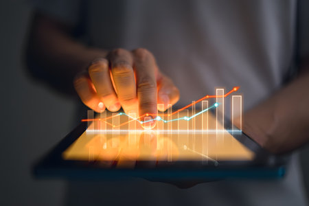 Businessman using tablet with graph chart on screen, stock market conceptの素材