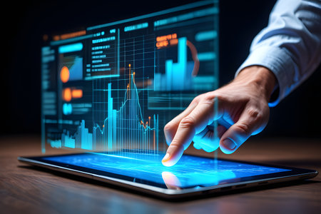 Close up of male hands using tablet pc with glowing charts and graphsの素材