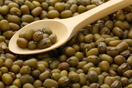 Background of mung beans and wooden spoonの写真素材