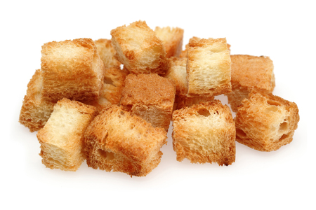 Tiny bread cubes isolated on white background. Macro, studio shotの写真素材