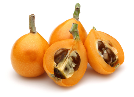 Ripe loquat, half and slice isolated on white backgroundの写真素材