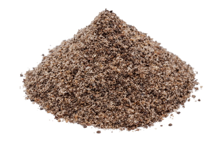 Heap of ground black peppercorn isolated on white backgroundの写真素材