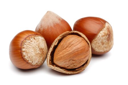 Whole and broken hazelnut isolated on white backgroundの写真素材