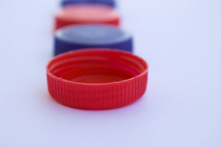 The first red plastic plug in a row focused