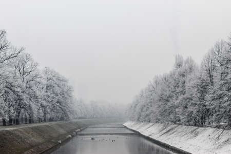 The Miljacka river in Sarajevo during the winter. In winter, Sarajevo has fog and pollution with little snow on the coast. Sarajevo, Bosnia and Herzegovina.の写真素材