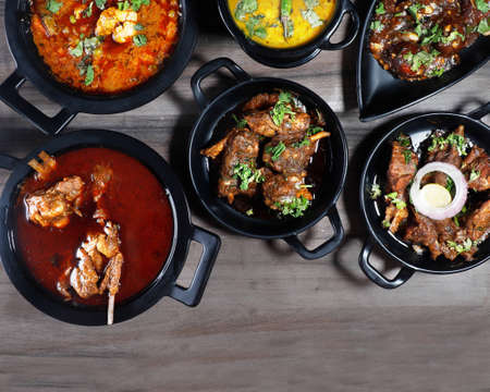 Assorted indian food on wooden background. Dishes and appetizers of indian cuisineの写真素材