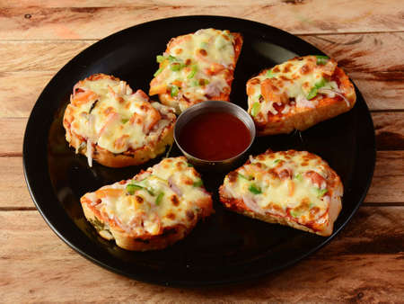 Cheese garlic bread, served over a rustic wooden background, selective focusの写真素材