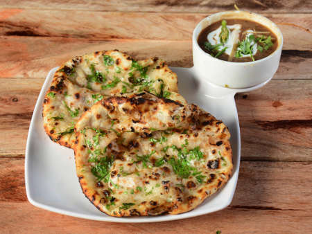 Chole Kulcha, Clay baked stuffed Naan served with channa masala or chole masala, typical meal of...